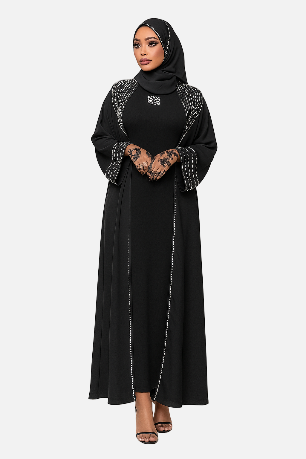 Woman wearing a black abaya with white embroidery on a white background