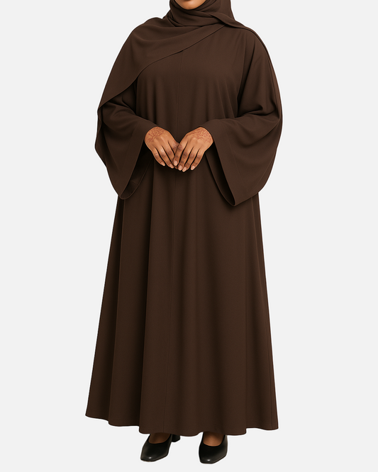 Woman wearing a brown abaya on a beige background